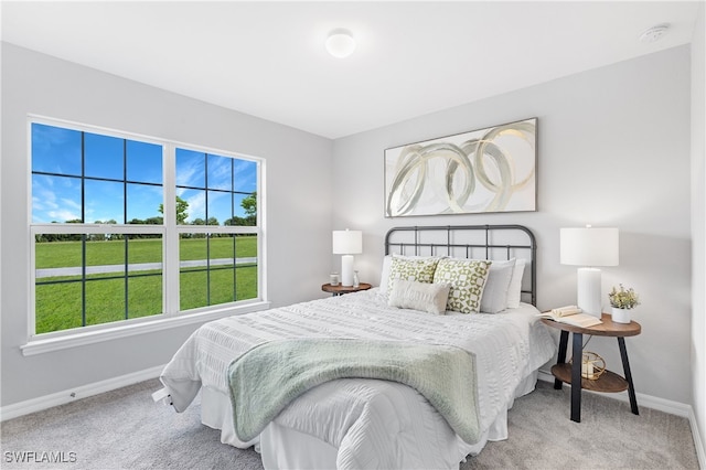 bedroom featuring carpet flooring and baseboards