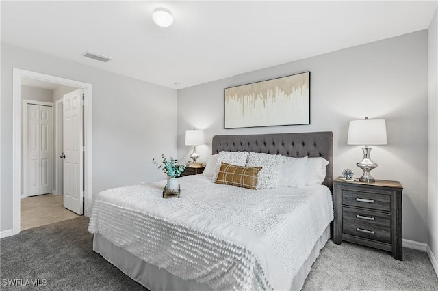 bedroom featuring light carpet, baseboards, and visible vents