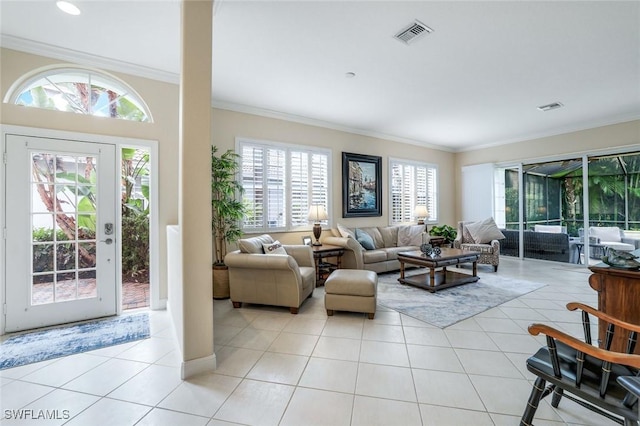 living room with visible vents, crown molding, and light tile patterned flooring