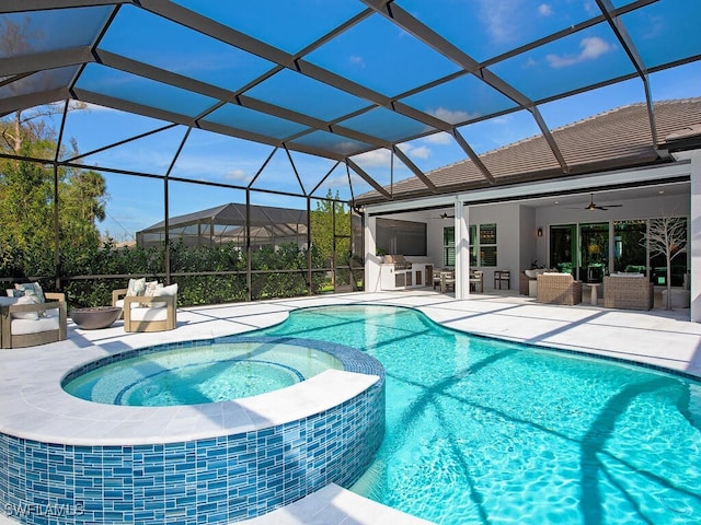 view of swimming pool featuring a pool with connected hot tub, outdoor lounge area, a ceiling fan, and a patio