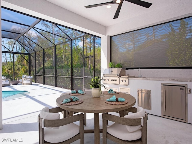 sunroom / solarium with a sink and ceiling fan