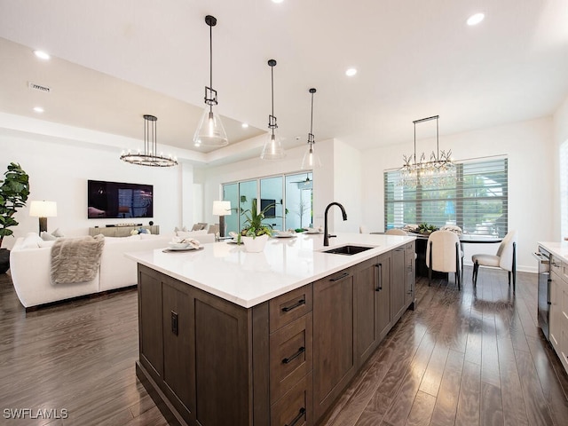 kitchen featuring a chandelier, dark wood finished floors, visible vents, and a sink