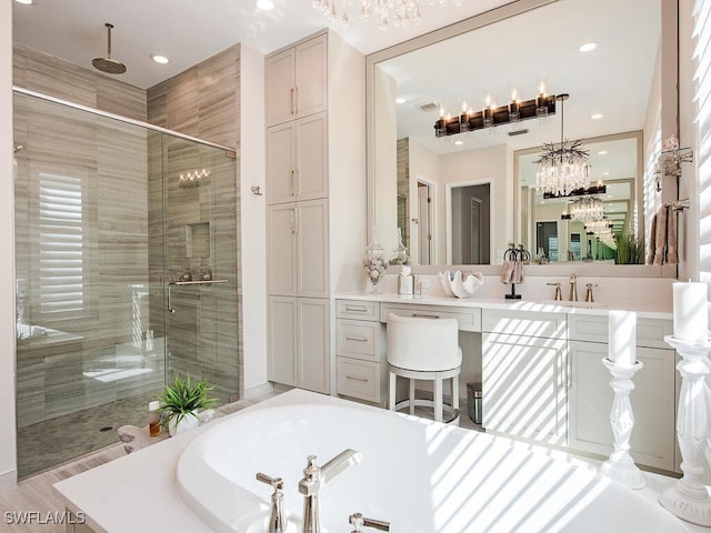 full bathroom featuring a stall shower, a garden tub, vanity, and recessed lighting