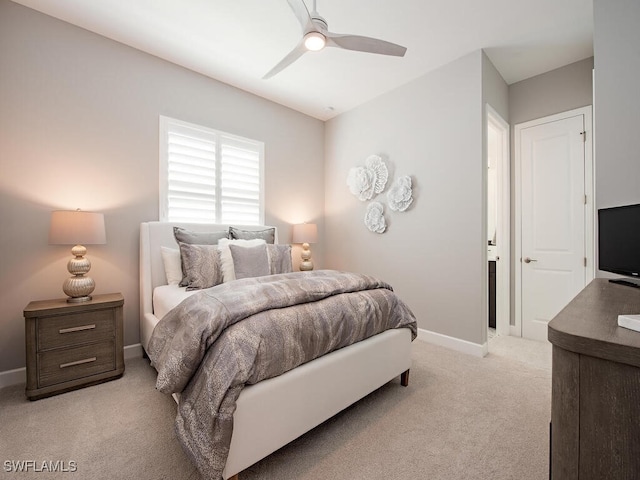 bedroom featuring light colored carpet, ceiling fan, and baseboards