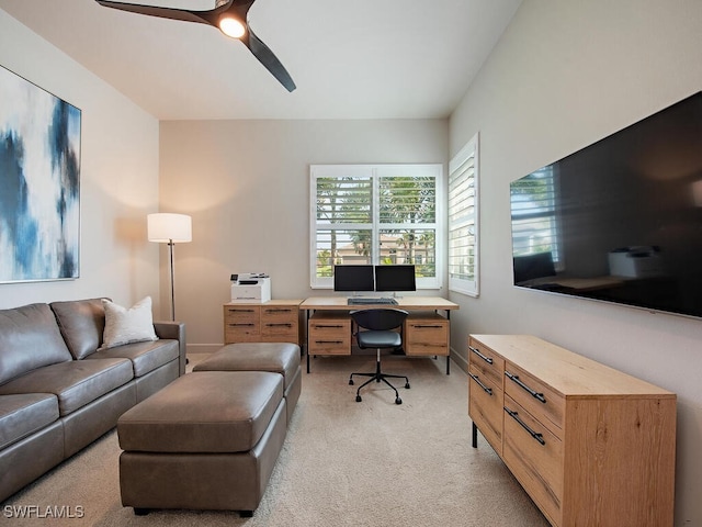 office space with light carpet, ceiling fan, and baseboards