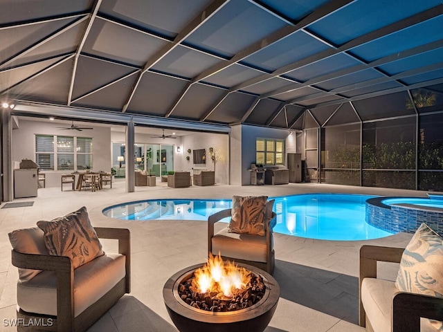 view of pool featuring a ceiling fan, a patio, an outdoor living space with a fire pit, glass enclosure, and a pool with connected hot tub