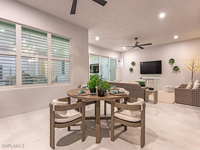 dining area with a textured wall, a ceiling fan, and recessed lighting