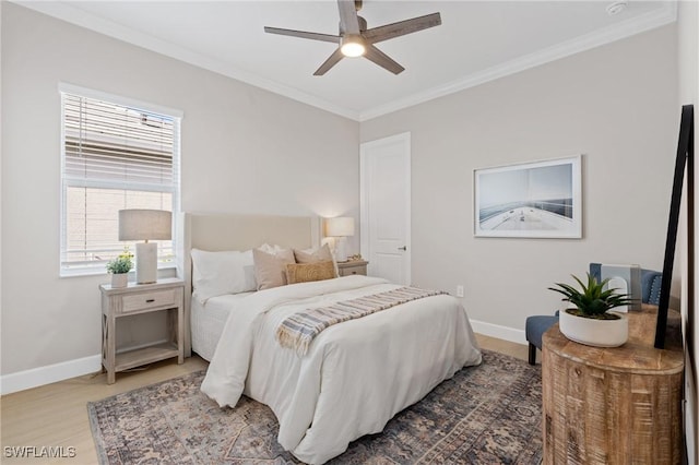 bedroom featuring crown molding, wood finished floors, baseboards, and ceiling fan