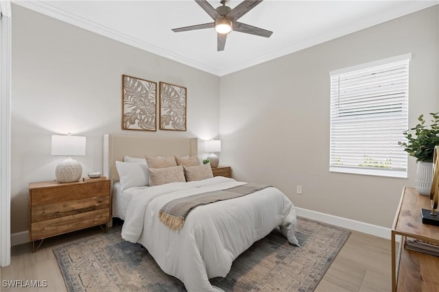 bedroom with ceiling fan, light wood-type flooring, baseboards, and ornamental molding