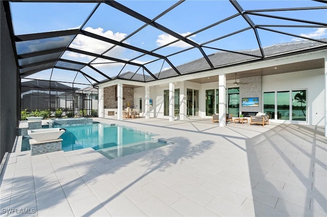 pool with glass enclosure, a ceiling fan, and a patio