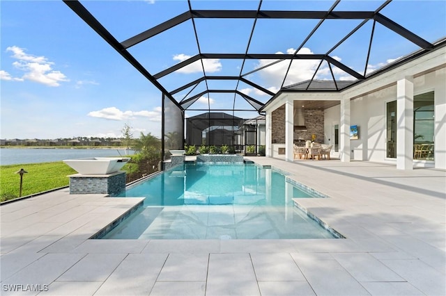 pool featuring glass enclosure, a patio area, and a water view