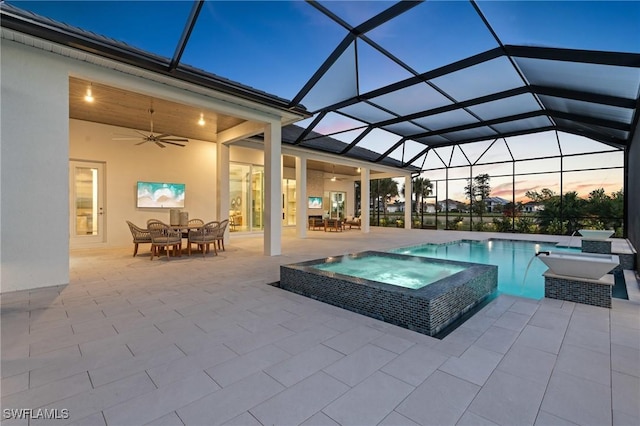 view of pool featuring a lanai, ceiling fan, and a patio area