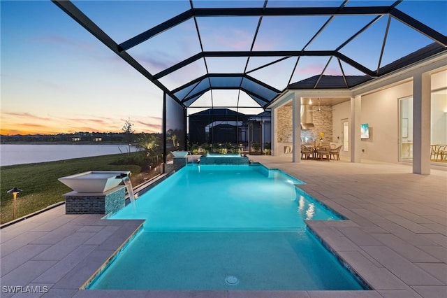 view of pool featuring a water view, a pool with connected hot tub, a lanai, and a patio area