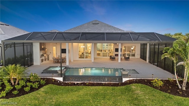 rear view of house with a patio, a pool with connected hot tub, outdoor lounge area, a lanai, and a lawn