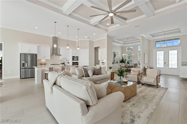 living room featuring beamed ceiling, ornamental molding, a high ceiling, coffered ceiling, and a ceiling fan