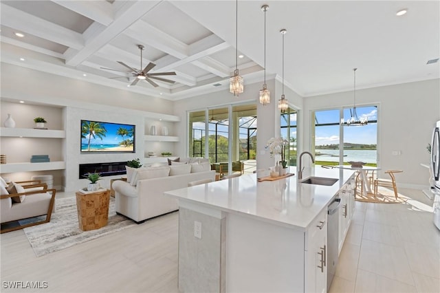 kitchen with built in shelves, coffered ceiling, beam ceiling, an island with sink, and a sink