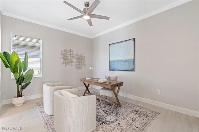 office area with light wood-type flooring, baseboards, crown molding, and a ceiling fan