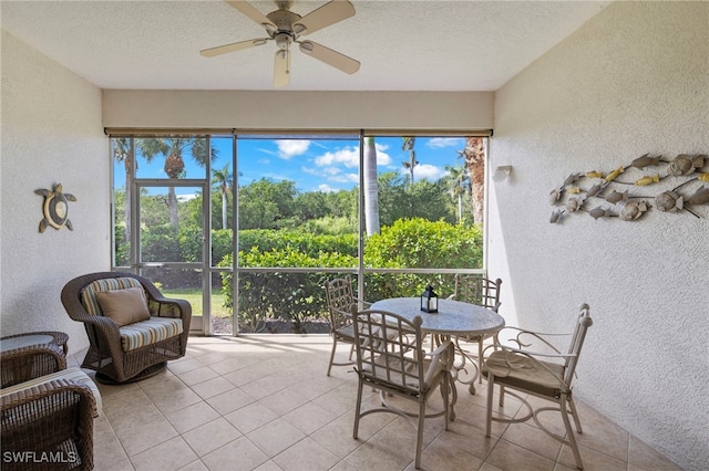 sunroom featuring a ceiling fan