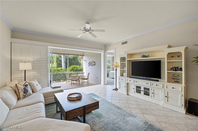 living area featuring tile patterned flooring, visible vents, ceiling fan, and crown molding