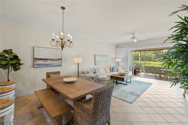 dining room featuring light tile patterned floors, baseboards, ornamental molding, and ceiling fan with notable chandelier