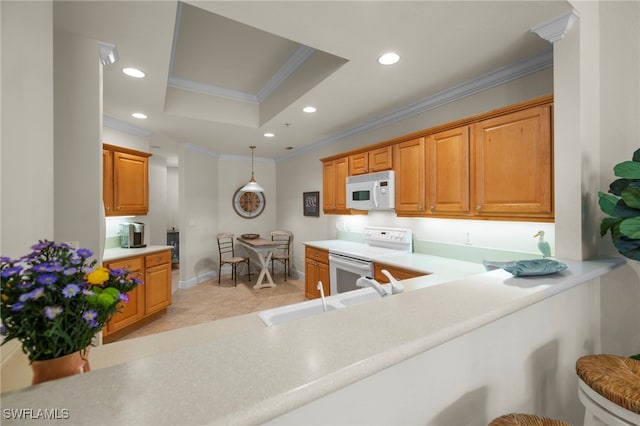 kitchen featuring white appliances, a raised ceiling, crown molding, a sink, and recessed lighting