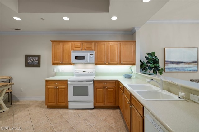 kitchen with crown molding, white appliances, light countertops, and a sink