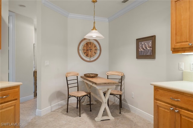 dining area with baseboards, ornamental molding, and light tile patterned flooring