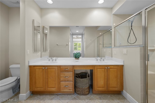 bathroom featuring double vanity, a sink, and a shower stall