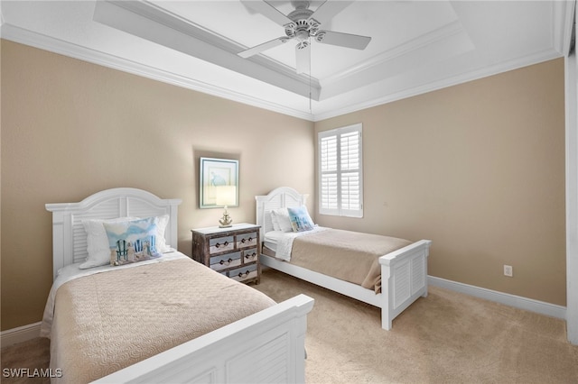 bedroom featuring light carpet, a tray ceiling, ornamental molding, and baseboards