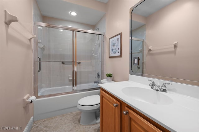 full bathroom featuring toilet, tile patterned flooring, enclosed tub / shower combo, and vanity