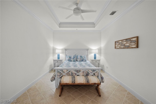 bedroom with baseboards, visible vents, a tray ceiling, and ornamental molding