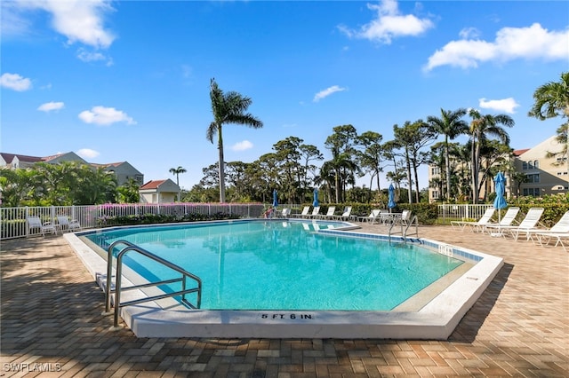 community pool featuring a patio and fence