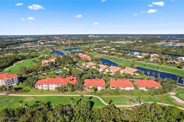 birds eye view of property featuring view of golf course, a water view, and a residential view