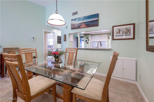 dining space with light tile patterned floors, visible vents, and baseboards