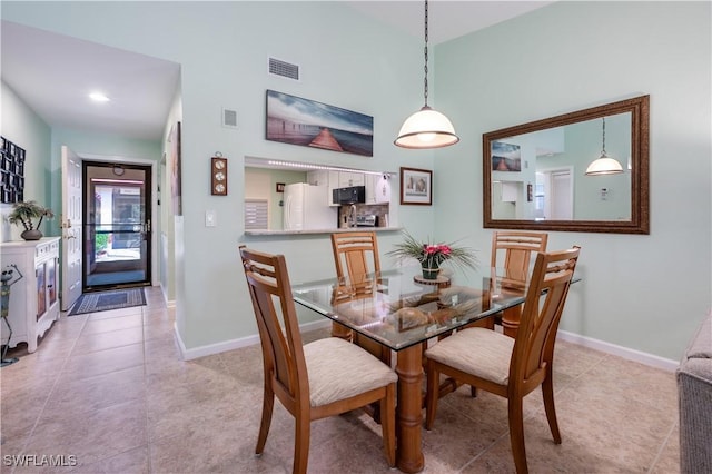 dining room featuring light tile patterned flooring, baseboards, and visible vents