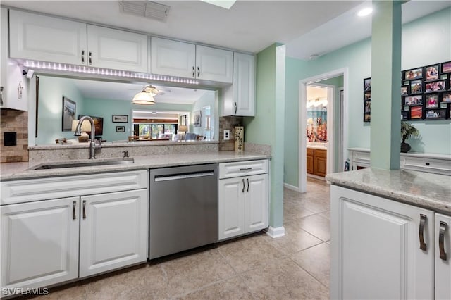 kitchen with visible vents, a sink, white cabinets, light tile patterned flooring, and dishwasher