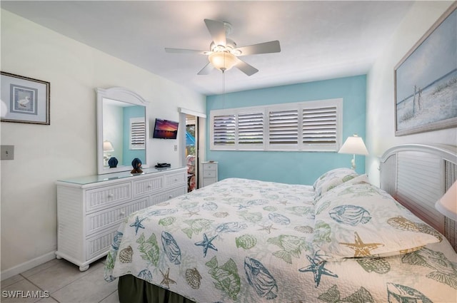 bedroom featuring light tile patterned flooring, baseboards, and ceiling fan