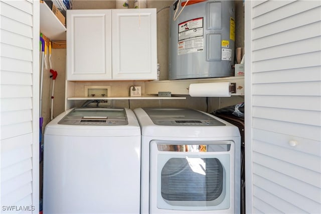 laundry area with washer and dryer, cabinet space, and water heater