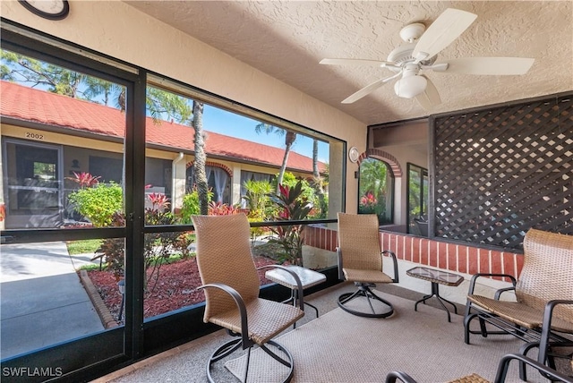 sunroom featuring ceiling fan