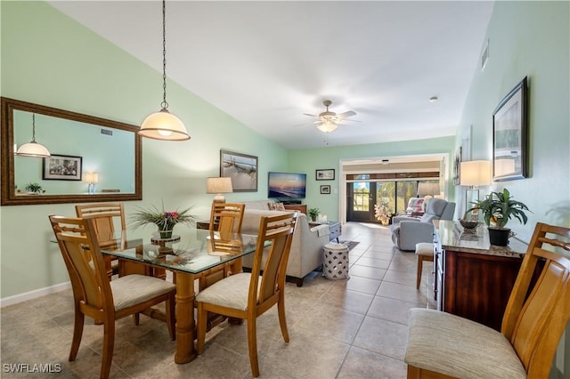 dining space with visible vents, baseboards, light tile patterned floors, lofted ceiling, and ceiling fan