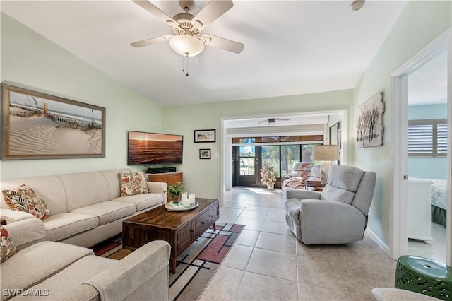 living room featuring light tile patterned floors, a ceiling fan, and baseboards