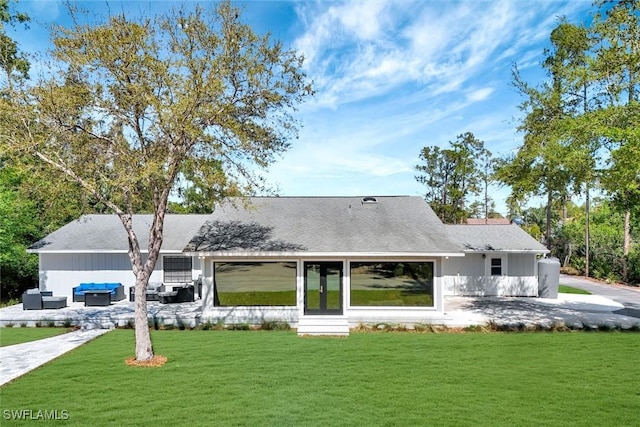 rear view of house with a patio area, outdoor lounge area, and a lawn