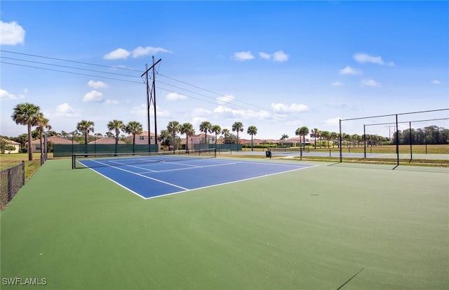 view of tennis court with fence