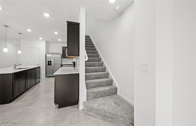 staircase with tile patterned flooring, baseboards, and recessed lighting