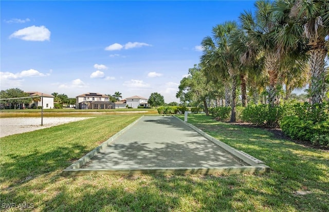 view of home's community with a lawn and volleyball court