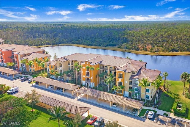 aerial view featuring a residential view, a water view, and a view of trees