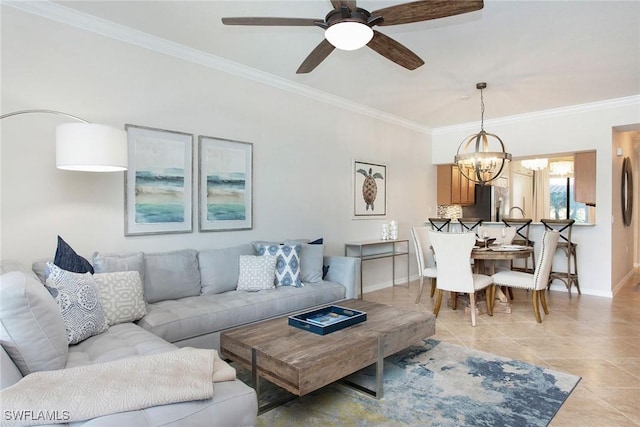 living room featuring light tile patterned floors, ornamental molding, ceiling fan with notable chandelier, and baseboards