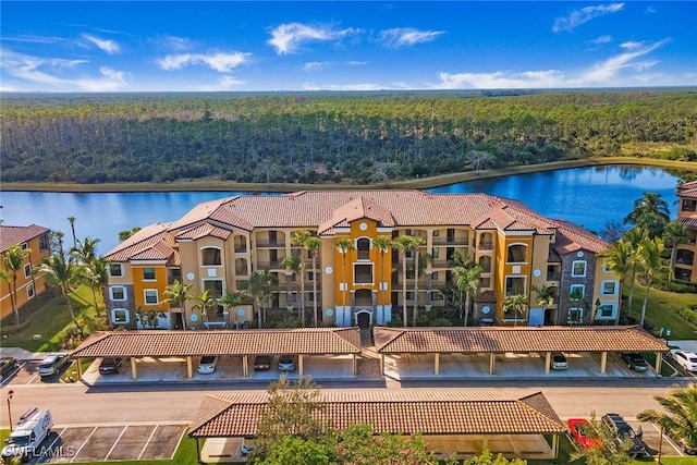 aerial view with a water view and a forest view