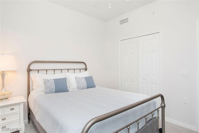 bedroom featuring a closet, carpet flooring, visible vents, and baseboards