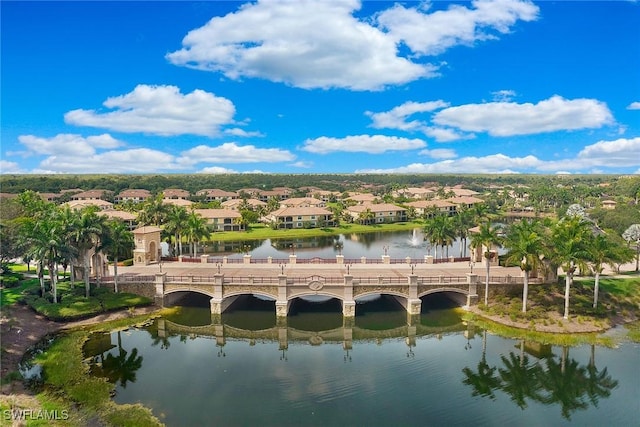 drone / aerial view with a residential view and a water view